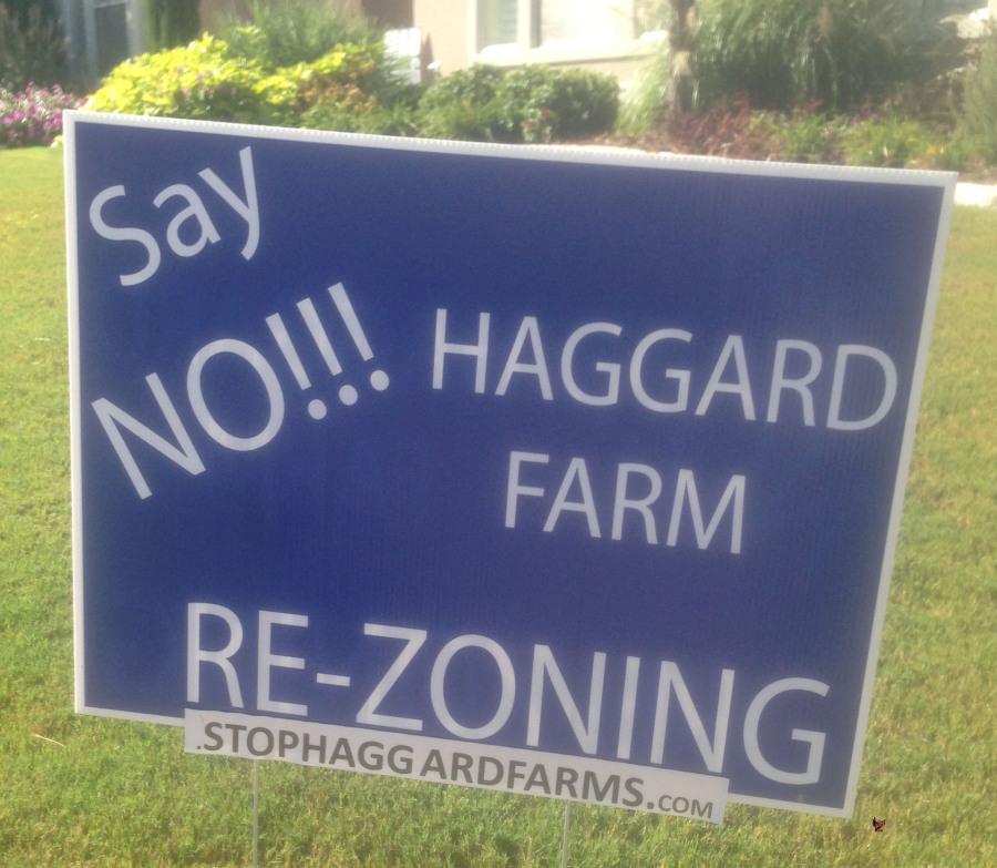 Plano residents use signs to protest the development of Haggard Farms