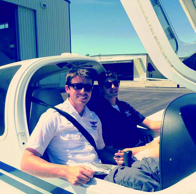 Preparing for take off with his flight instructor, senior Caden Mazzu (right) savors his time in the air. 