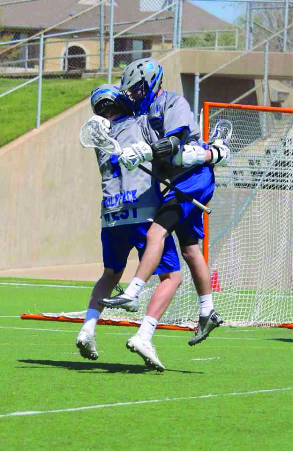 Rejoicing after scoring a goal, junior Jacob Carter and senior Andrew Brown celebrate on the field. 