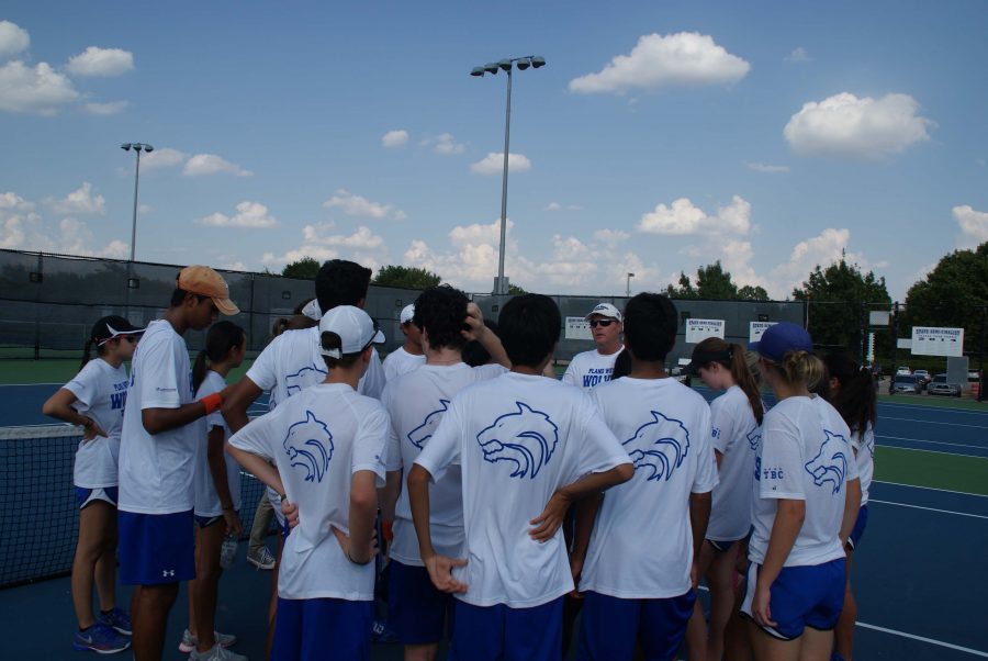 The tennis team listens to directions from Coach Walker. 