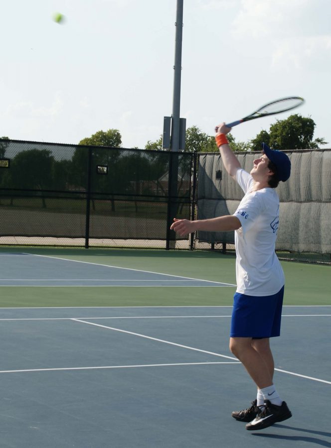 Senior Mark Kanevsky prepares to hit the tennis ball. 