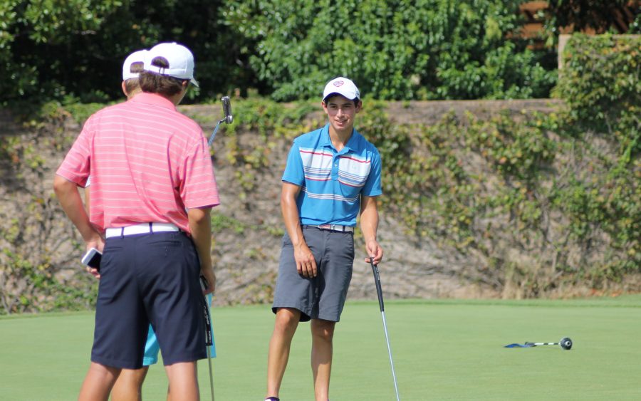 Senior Bryce Pidgeon stands on the green with teammates Pierceson Coody and Andy Lopez.