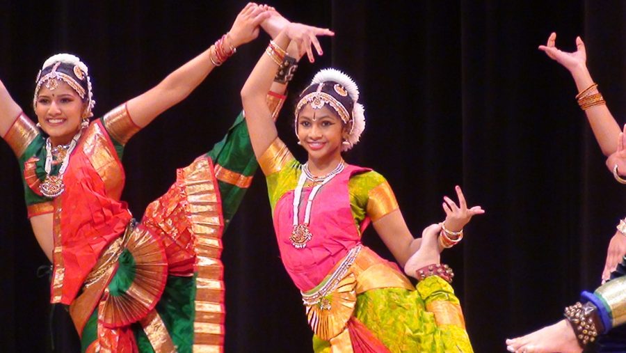 Junior Apoorva Kakkilaya (right) performs in her  dance school's annual recital.
