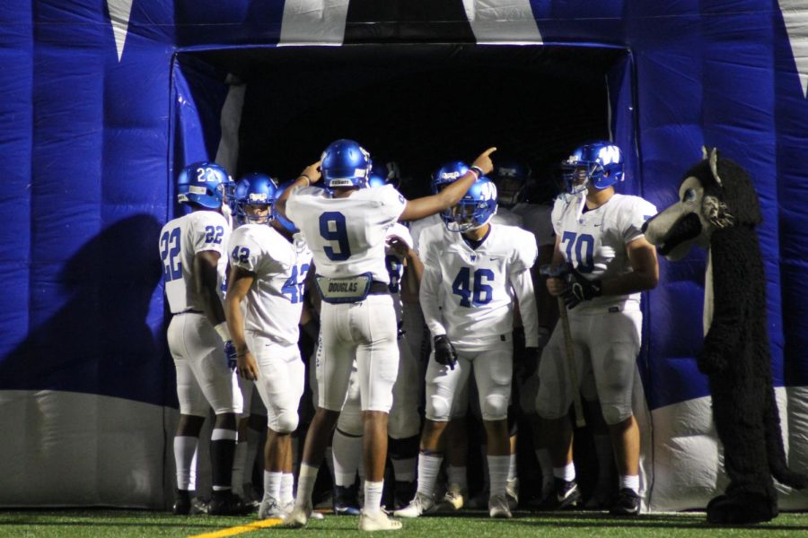 Plano West WR Tavarius Garland (#9) hypes the team up in the tunnel before a game against Plano Senior.
