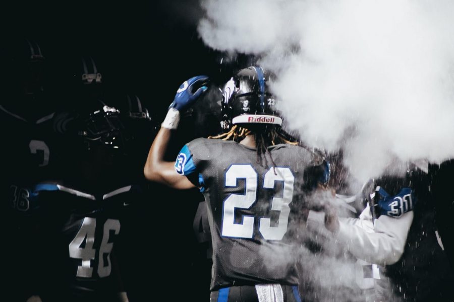 West linebacker Jared Brumfield (#23) huddles with the team before a game.