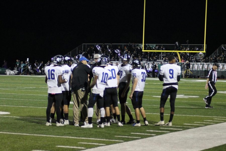 Plano West Head Coach Scott Smith talks with the offense in a huddle in last week's game against Prosper.
