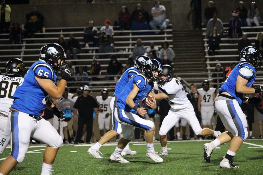 Plano West QB Will Cannon (#4) looks to pick up a few yards on a rush. Cannon threw for 117 yards against Plano East.
