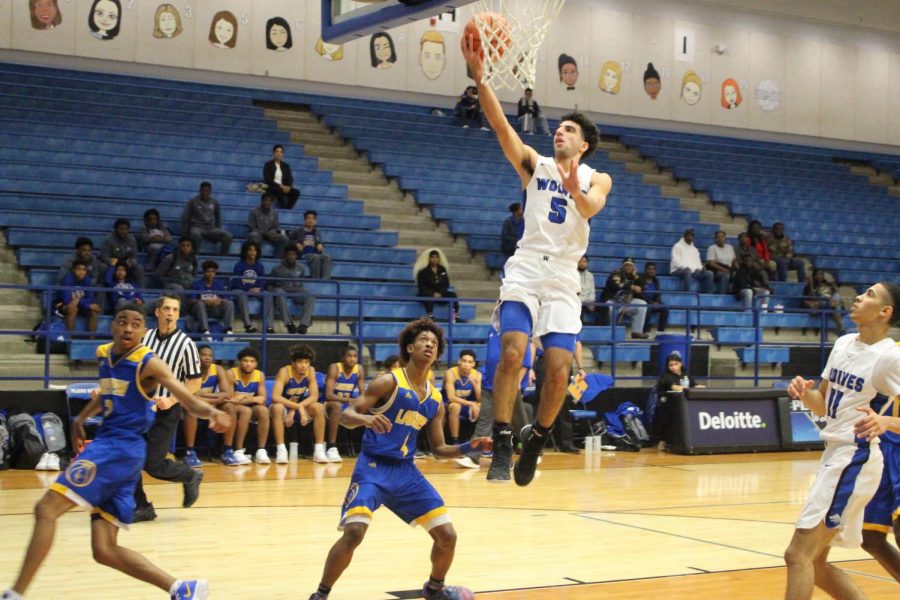 Senior guard Ryan Zambie (#5) puts in a layup for two points.