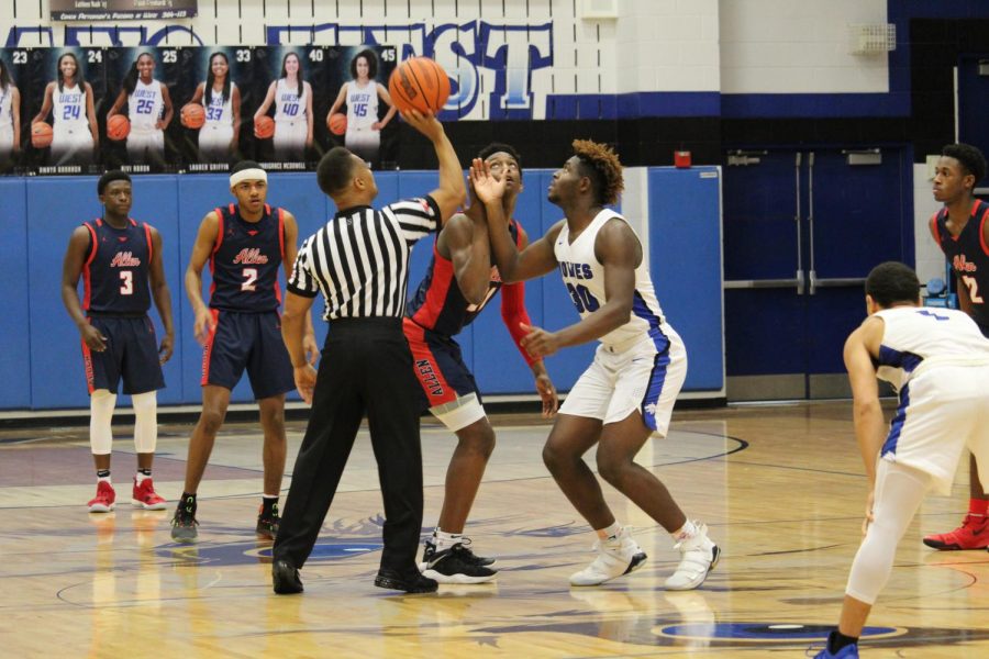 Plano West's Shemar Pearl (#30) looks to get to ball off the tip off at the beginning of the game.