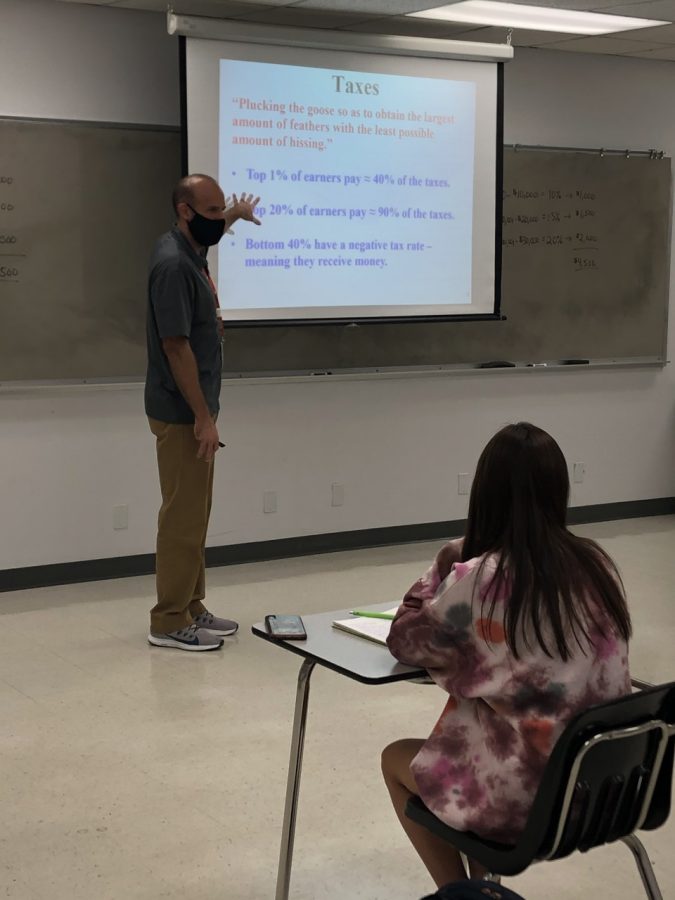 Collin economics professor Daniel Sattizahn explains regressive and progressive taxes to students on Wednesday, November 4.