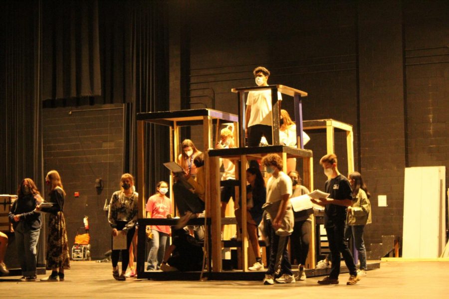 Plano West Theatre students practice a scene for the play.