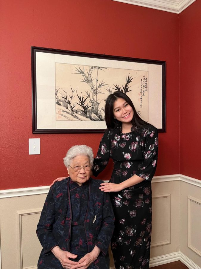 Katie Chou, 11, and her grandma shares a photo while Katie is in a Qi Pao passed down to her. 