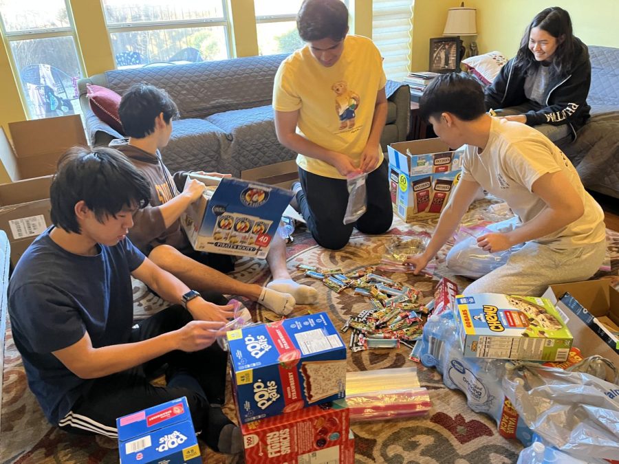 WeCare DTX members gather around creating care packages 