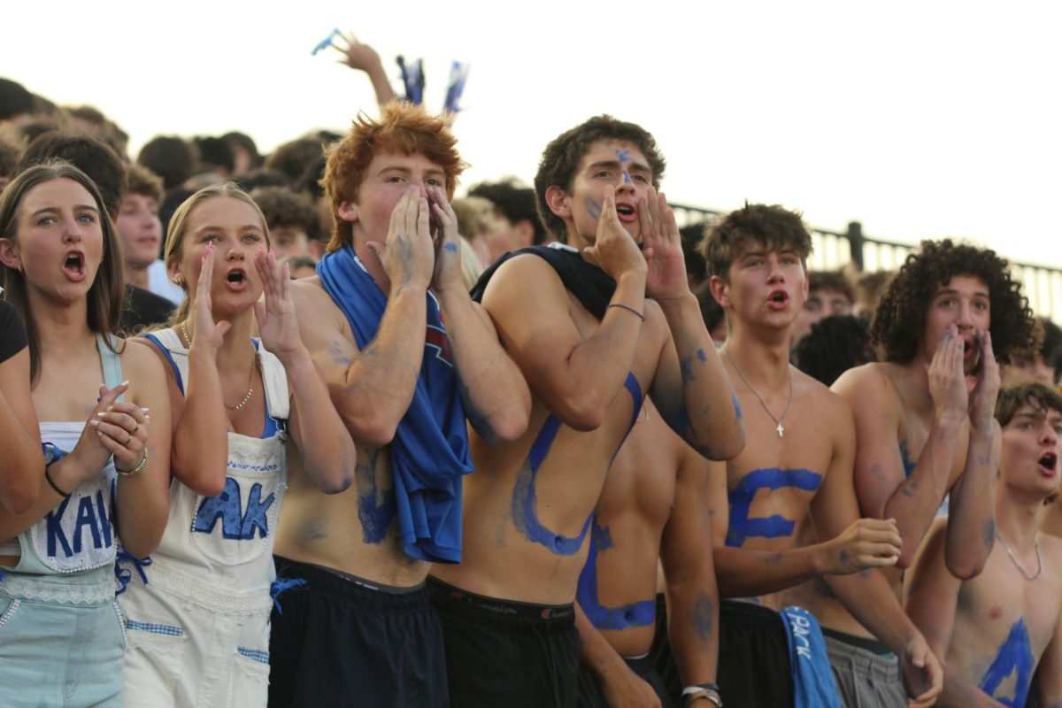 WOLF PACK POWERHOUSE
As the varsity football team take on McKinney Boyd High School, seniors Gavin Jones and Lucas Chavarria cheer on the players at the homecoming game Friday, Sept. 12. The Wolves took home the win after a comeback in at the end of the second quarter. "I go to a lot of my friends games, for different schools like [Rick] Reedy or Allen and the student sections aren’t as lively," Jones said. "I would say we're more unified, for sure. We have the same goals. Because the football team is so unexpectedly good this year, it's definitely made the student section more loud."
Photo by Ronan Knox