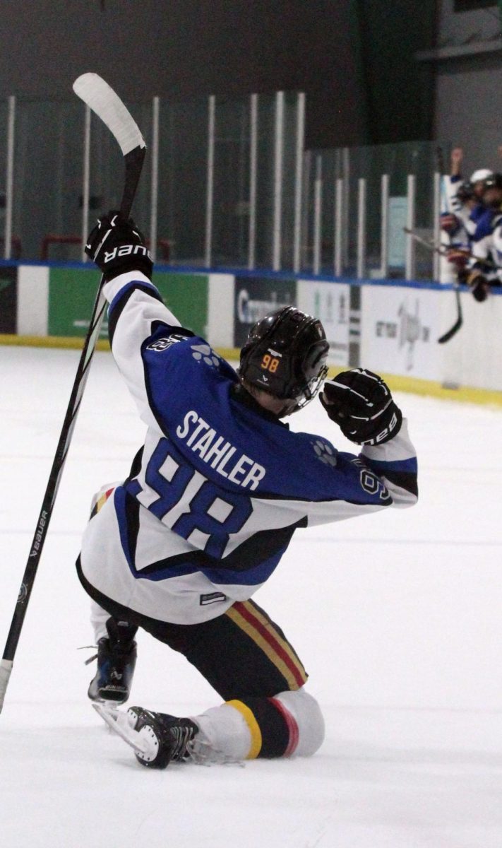 Striking a Pose
After his fourth, game-tying goal, junior Jay Stahler, forward, #98, celebrates at the varsity ice hockey game against West Texas Sunday, Sept. 21, at the Plano Star Center.
“Oh, it was awesome,” Stahler said. “I was I was jumping up. It was just electric. It was an electric feeling out there. It was a great pass to my boy Cam [Marver], and that game, I mean, [it] sealed the game right there.”