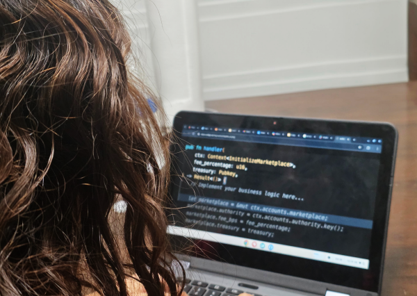 Photo illustration of girl using AI on her computer during class to help on assignments.