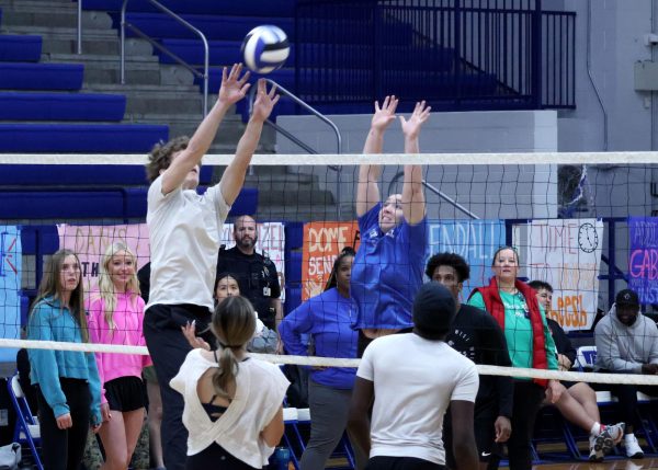 STUDENT V STAFF
As senior Andrew Merrefield attempts to hit the volleyball over the net, senior Payton Cook leaps to defend the staff team at the student vs. staff volleyball game during B-lunch Thursday, Dec. 11.
Cooks played on the staff side because not enough staff members signed up to play.